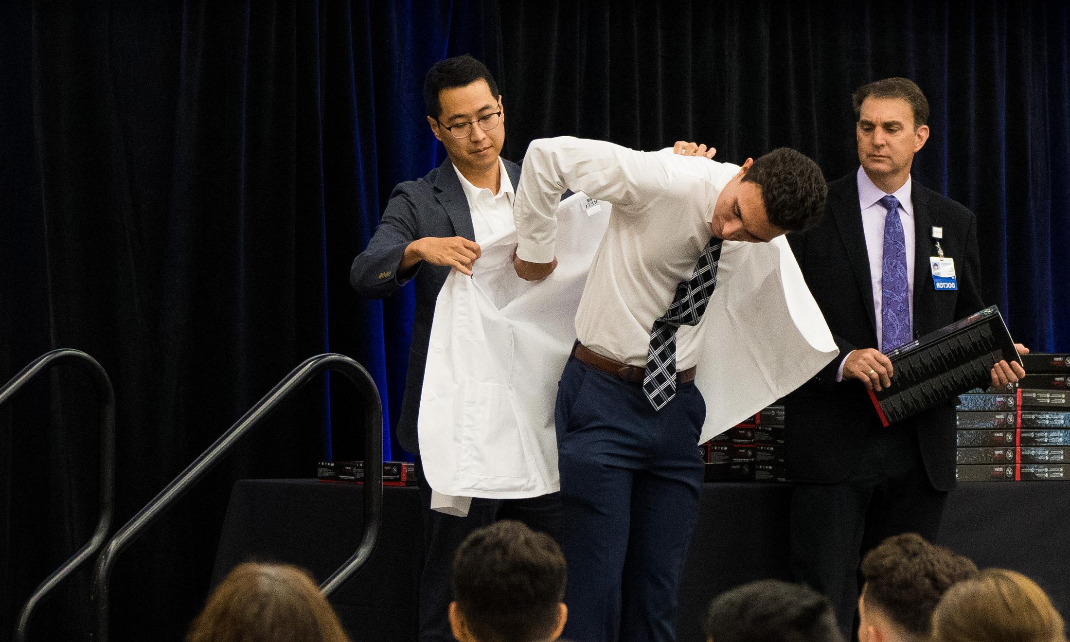 An image of a student getting a white coat