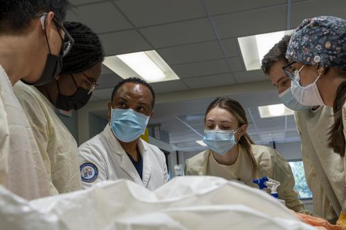 An image of FMS faculty in the anatomy lab with students